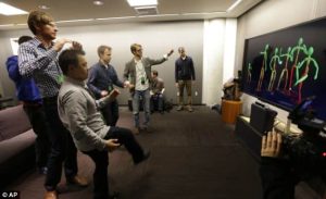 A group of journalists try out the improved motion-detecting capabilities of the new Kinect sensor for Microsoft's Xbox One console system.