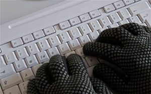 computer keyboard hands gloves typing spy hacker hacking spying phishing cyber crime criminal IT password PIN TAN computer virus